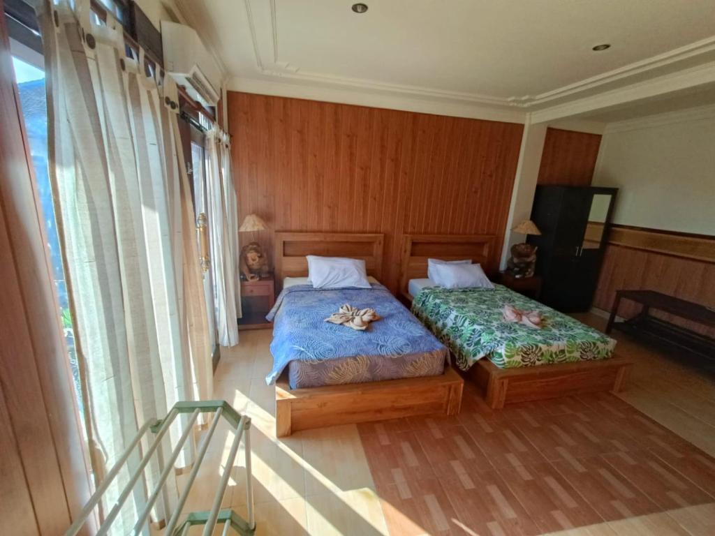 Postel nebo postele na pokoji v ubytování wahyu accomodation