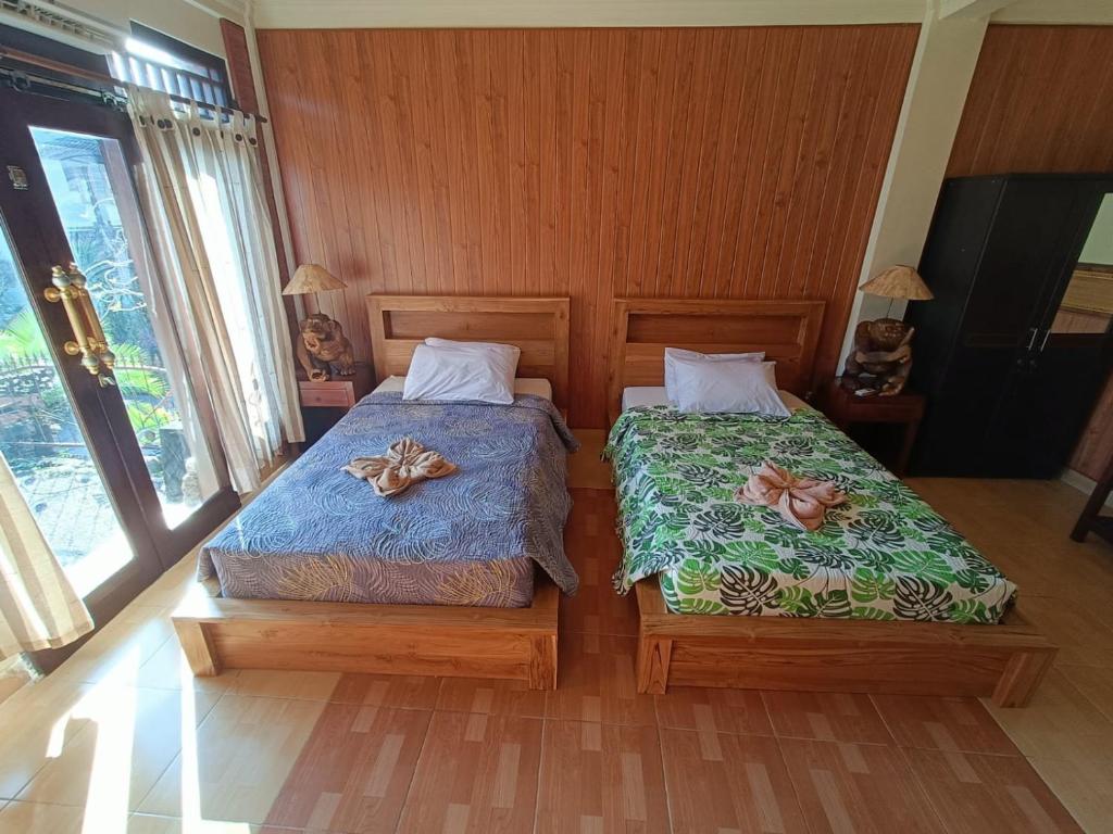 Postel nebo postele na pokoji v ubytování wahyu accomodation