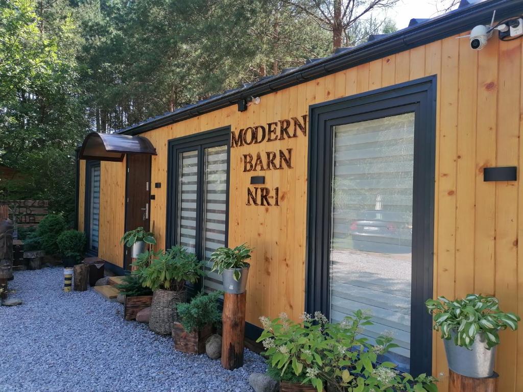 a wooden barn with a sign on the side of it at Domek Modern Barn 1 Całoroczny 800m od Park Wodnego Suntago Ranczo Gold Mania in Krzyżówka