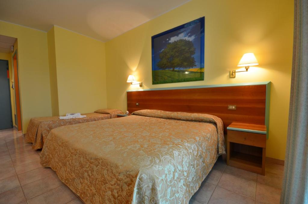 Posteľ alebo postele v izbe v ubytovaní Hotel Parco degli Ulivi