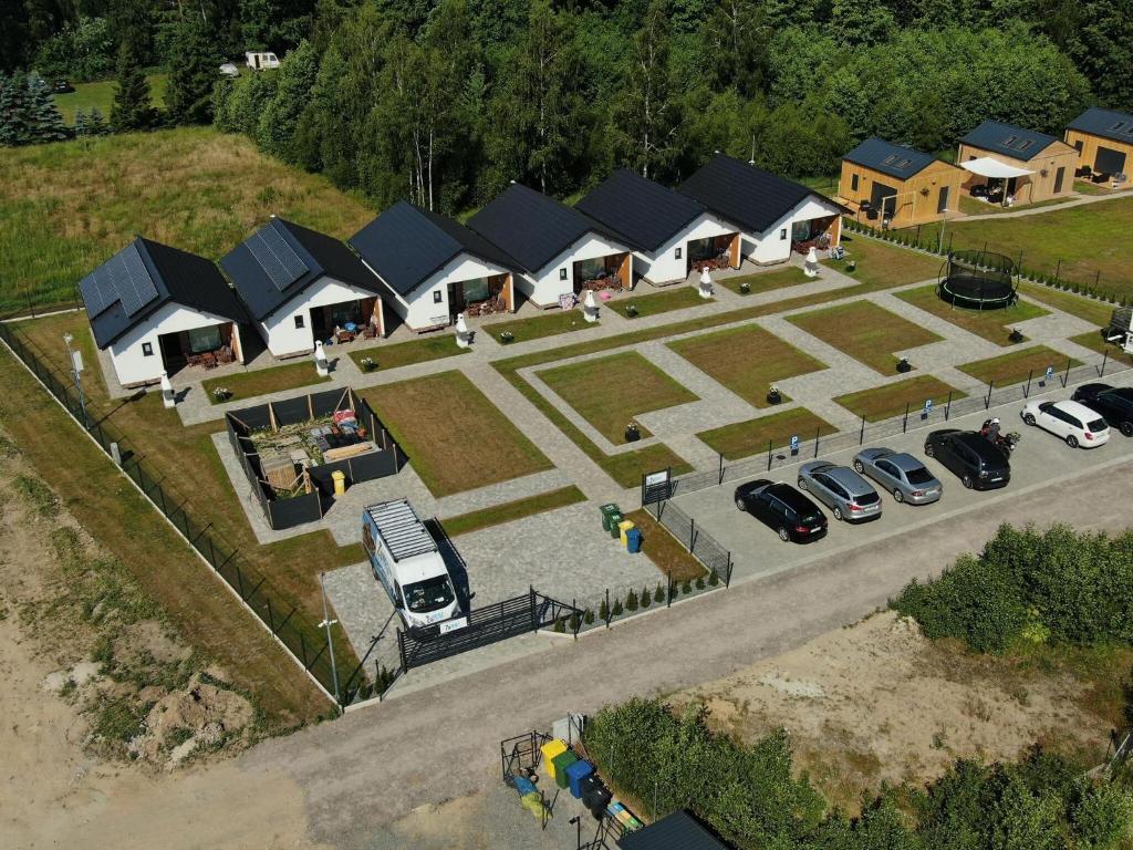 an overhead view of a row of houses with parked cars at Holiday cottages, Wicie in Wicie