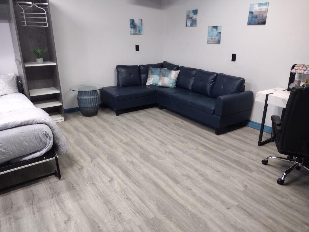 a living room with a couch and a bed at Luxury In A Quaint Little Package in Oshkosh