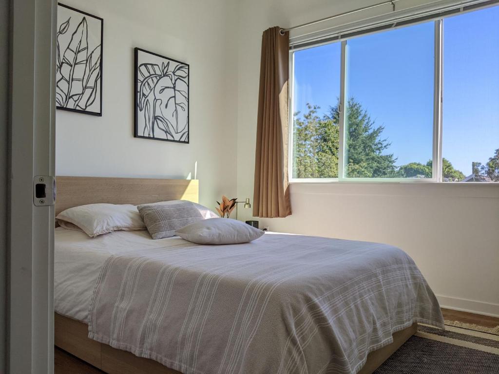 a bedroom with a bed with a large window at A premier luxurious smart condo with parking in Seattle