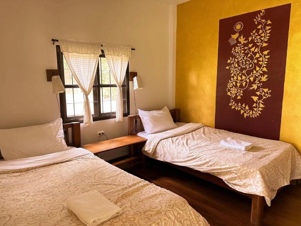 Postel nebo postele na pokoji v ubytování Pairadise Hotel