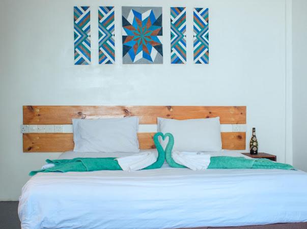 a bedroom with a bed with a mermaid on it at Tavern Lodge Maafushi in Maafushi