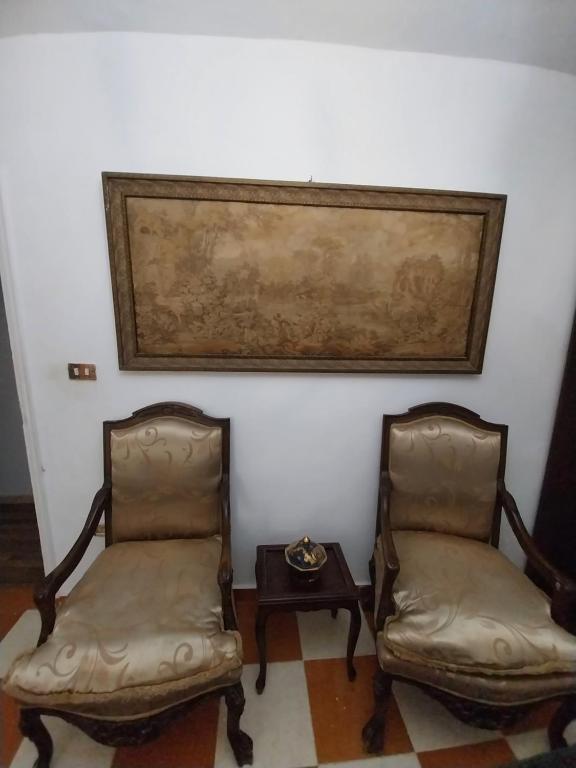two chairs and a table in a room at Shery''s home in 6th Of October