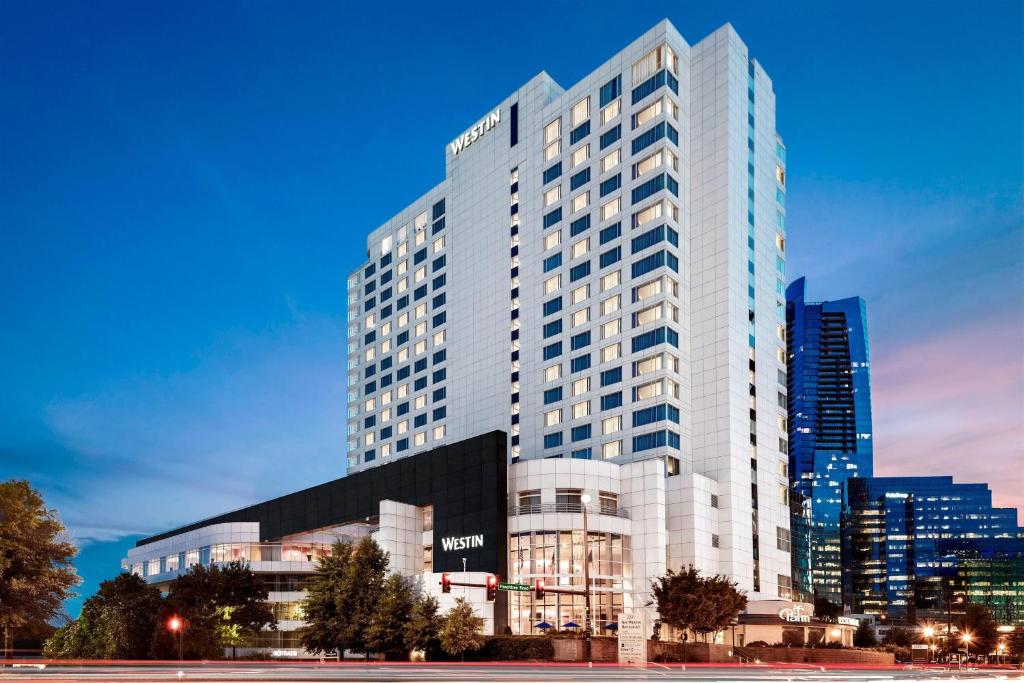 a tall white building in front of a city at The Westin Buckhead Atlanta in Atlanta