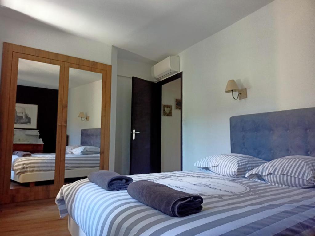 a bedroom with two beds and a mirror at un gîte dans la cité in Carcassonne