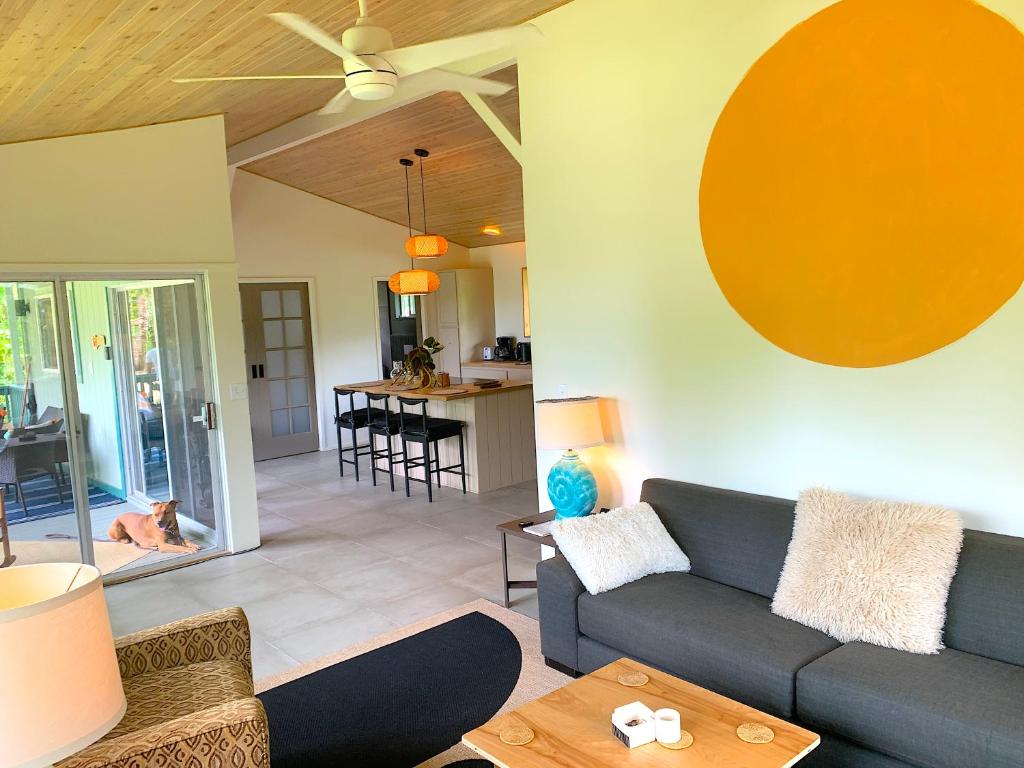 a living room with a couch and a table at Seaside House and Aloha Bungalow in Pahoa