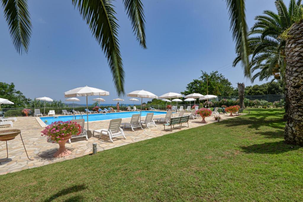 a pool with a bunch of chairs and umbrellas at Le Lecce 34 in Capoliveri