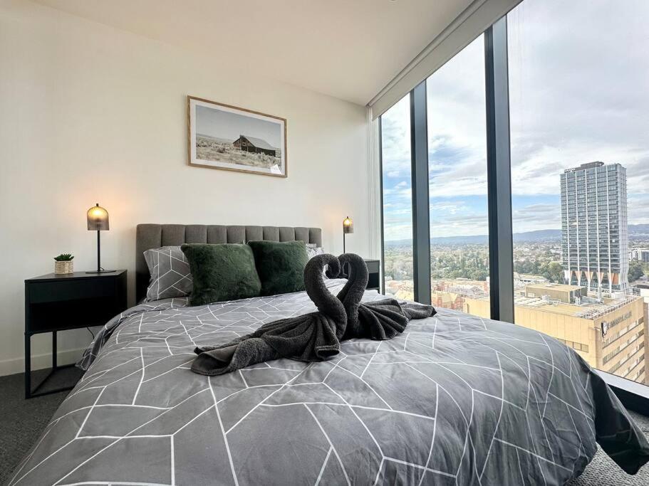a bedroom with a large bed with a swan on it at Luxury Top Level 1 Bedroom Apartment with Stunning View in Adelaide CBD - 1 minute walk to Rundle mall - Free Wifi & Netflix in Adelaide