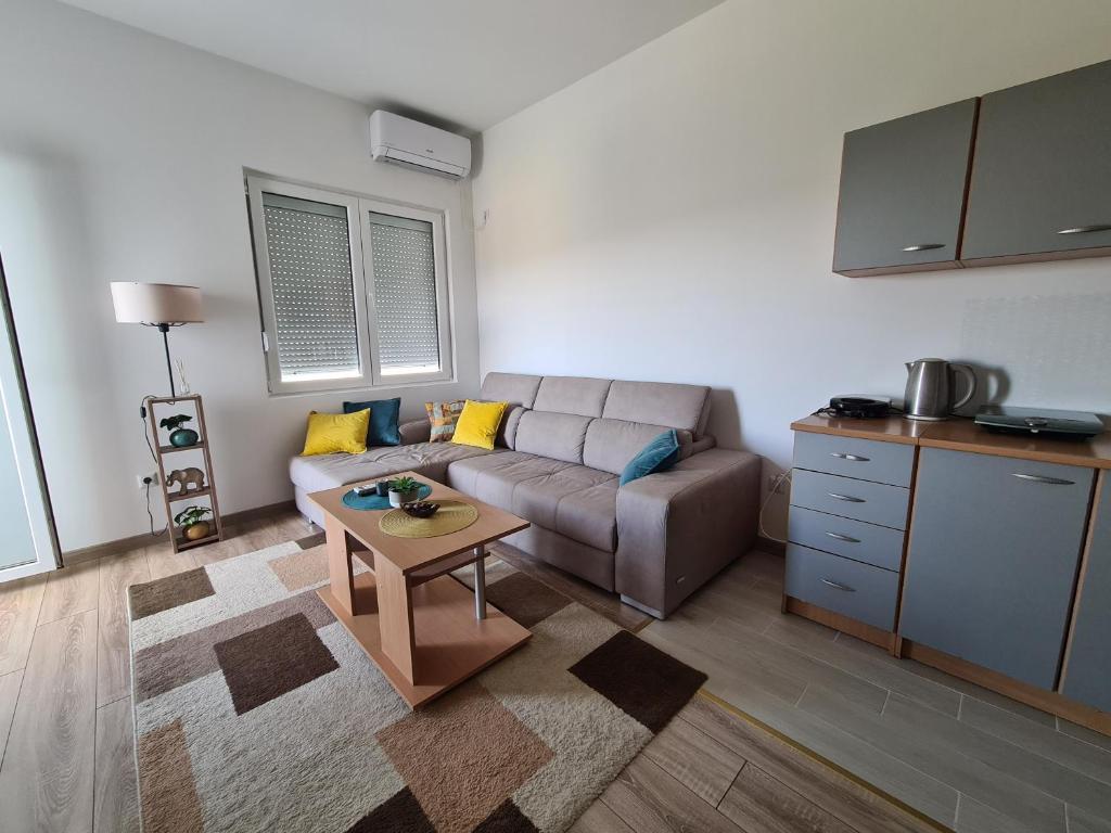 a living room with a couch and a table at Linda apartment in Ulcinj