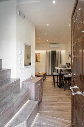 a living room with a staircase and a dining room at Guest house (Gastouri) in Gastouri