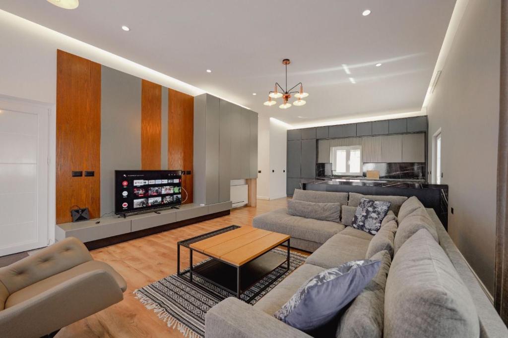 a living room with a couch and a table at Vila Osmani in Ksamil