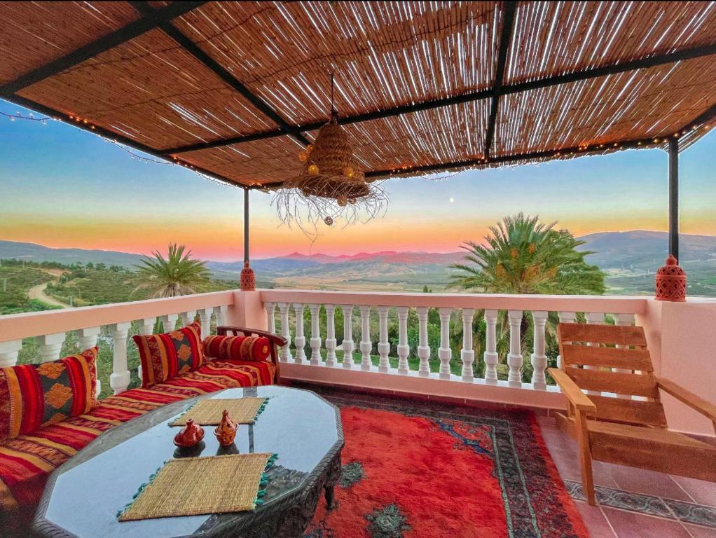 a balcony with a couch and a view of the mountains at Dar Bakkali Nadi in Tangier