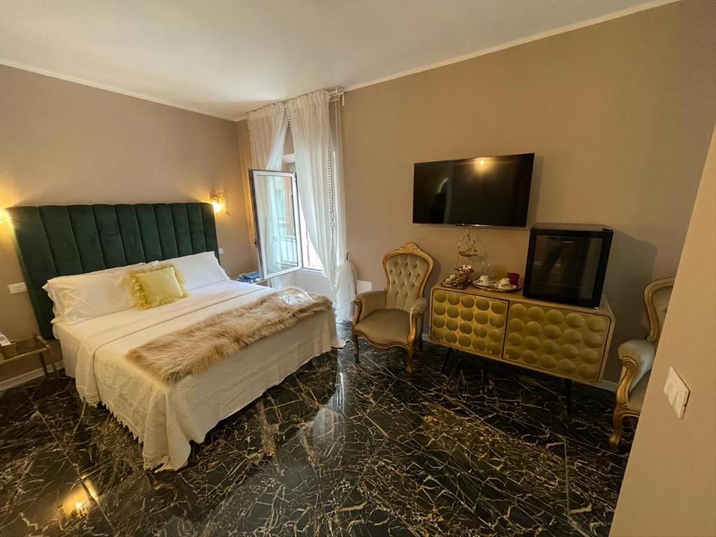 a bedroom with a bed and a flat screen tv at Prestige Suite Via Romagnoli in Sirmione