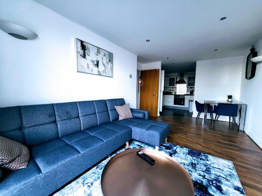 倫敦的住宿－Excel Manor，客厅配有蓝色的沙发和桌子