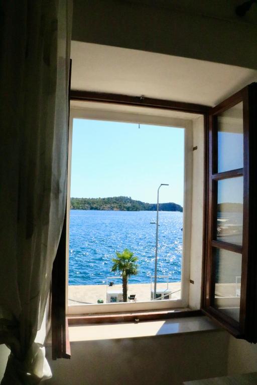 a window with a view of a body of water at Appartment Riva view in Šibenik