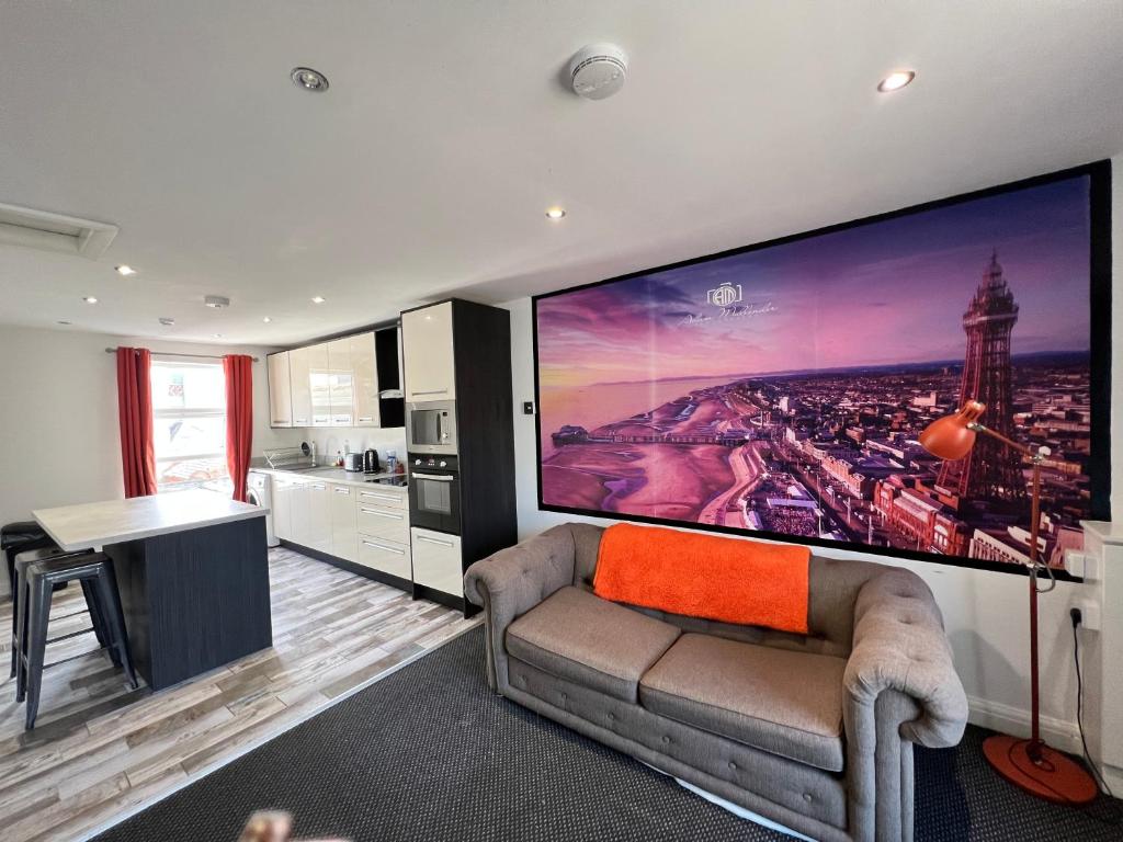 a living room with a large tv on the wall at Tower Suite Serviced Apartment Blackpool in Blackpool