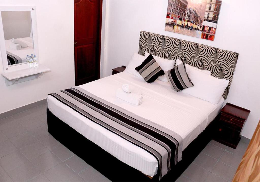 Postel nebo postele na pokoji v ubytování Cozy Inn Negombo