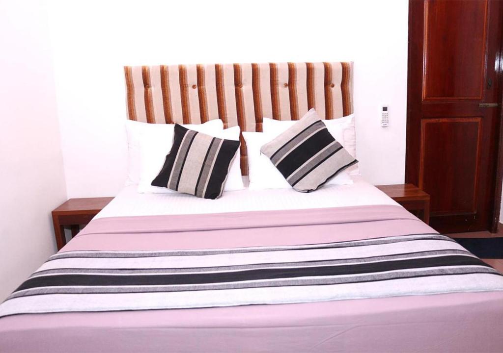 Postel nebo postele na pokoji v ubytování Cozy Inn Negombo