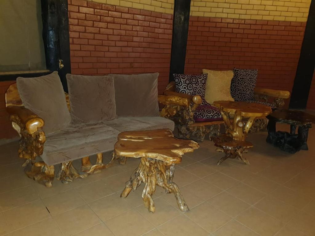 a living room with a couch and a table at Masai Mara Explore Camp in Narok