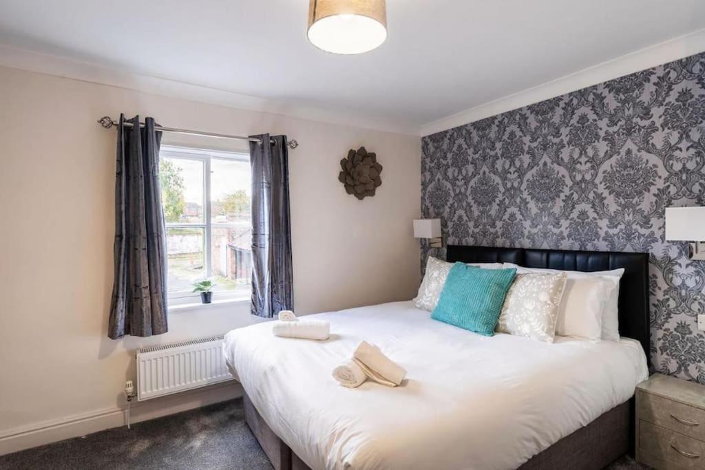 a bedroom with a large bed with a window at Quaint listed home in Barton in Barton upon Humber