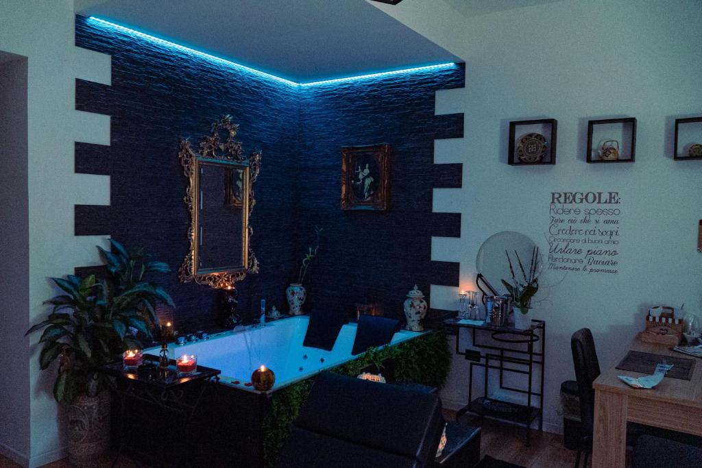 a living room with a large bathtub with blue lighting at Palmina's Apartments in Brindisi