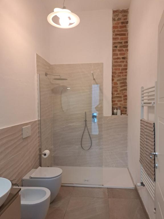 a bathroom with a shower with a toilet and a sink at Dimora Boezio7, cozy and charming place in center with private parking in Pavia