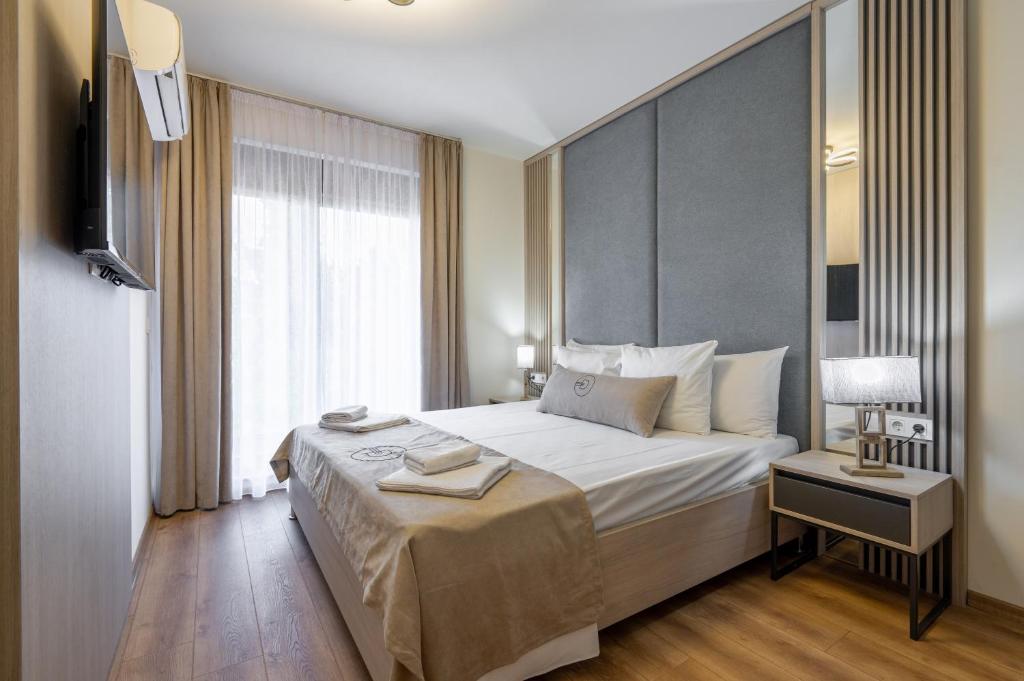 Postel nebo postele na pokoji v ubytování Dulamerovic Hotel