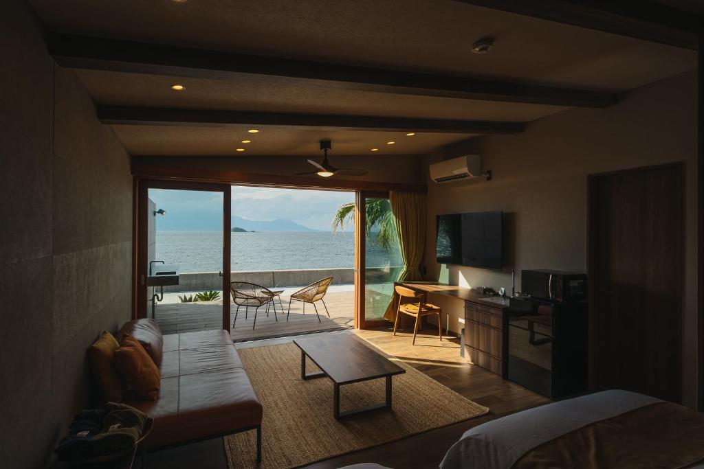 ein Wohnzimmer mit Meerblick in der Unterkunft L'isola THE BIRD in Kami Amakusa