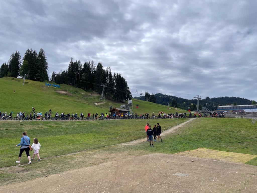 a group of people walking on a grassy field at GESPERE LE STELLA in Les Gets