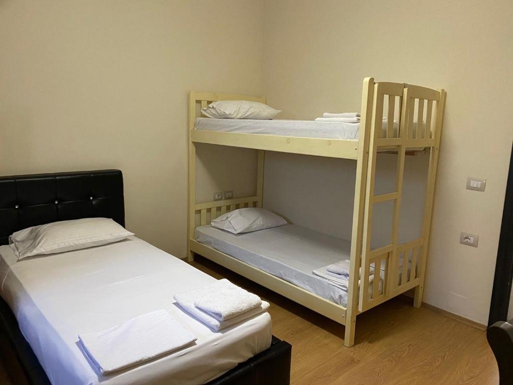 two bunk beds in a small room with two beds at Grand Park Hotel in Gjirokastër
