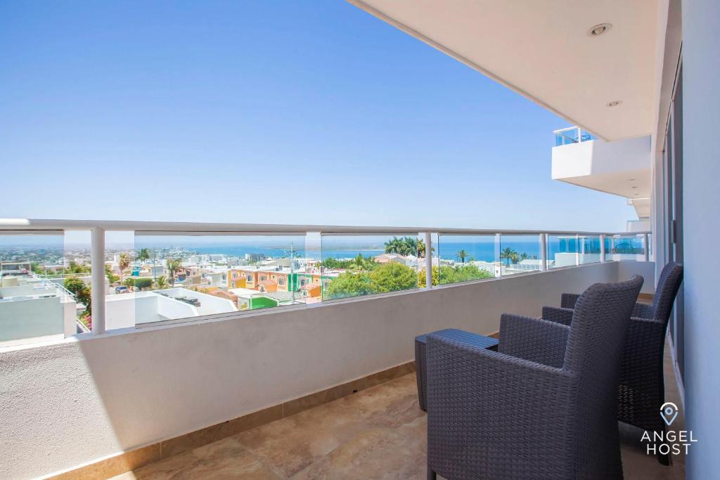 a balcony with chairs and a view of the ocean at Oceanview Living Space & Balcony with FiberOptic WiFi! in La Paz