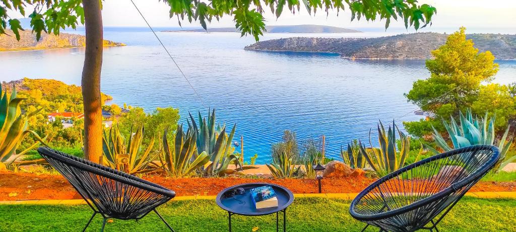 a swing with a view of a body of water at Avatonblue Villa Nafplio in Vivari