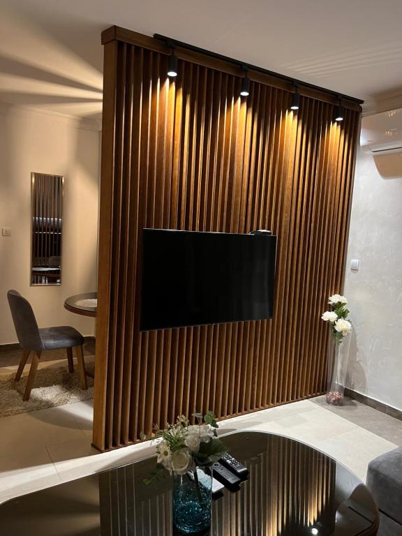 a living room with a large television on a wall at Stepa in Belgrade