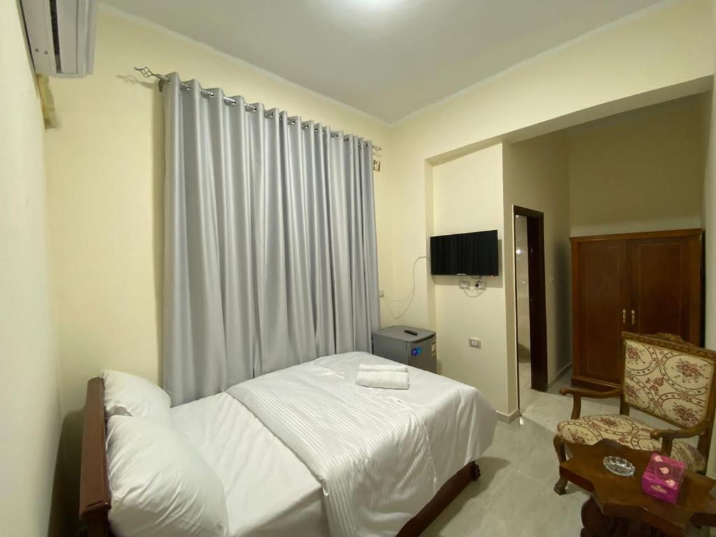 Postel nebo postele na pokoji v ubytování Sneferu Hotel