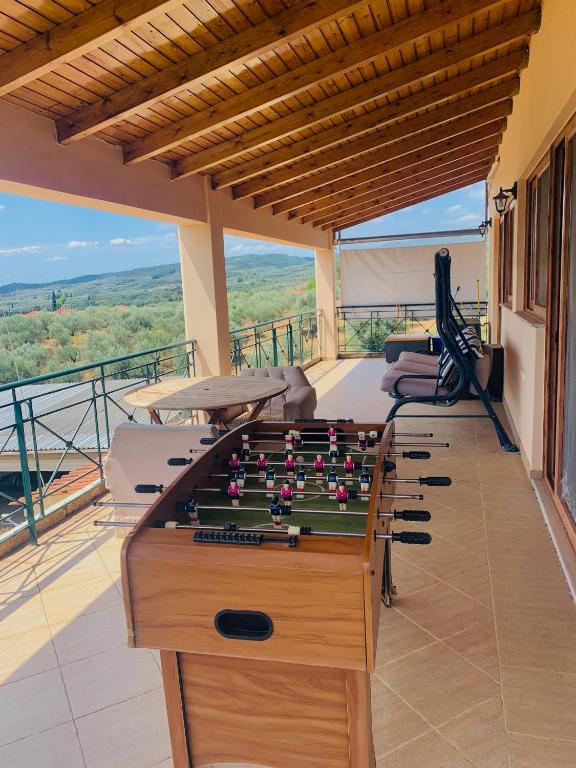 a pool table on the balcony of a house at BOKAS EXOTIC HOUSE in Tragána