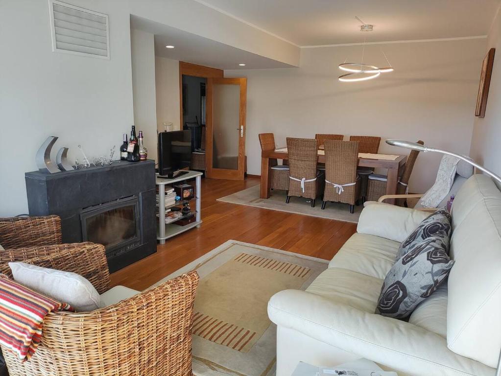 - un salon avec un canapé blanc et une cheminée dans l'établissement Furadouro Pool&Beach Apart, à Ovar