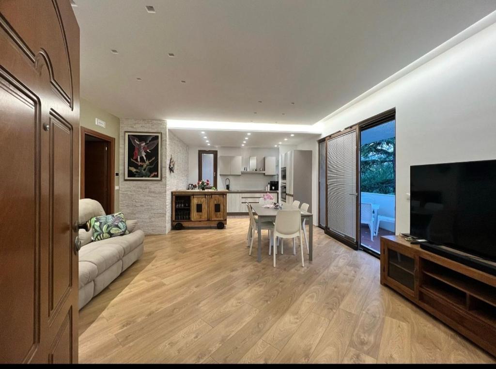a living room with a couch and a table and a television at La Villetta sul Mare in Vasto
