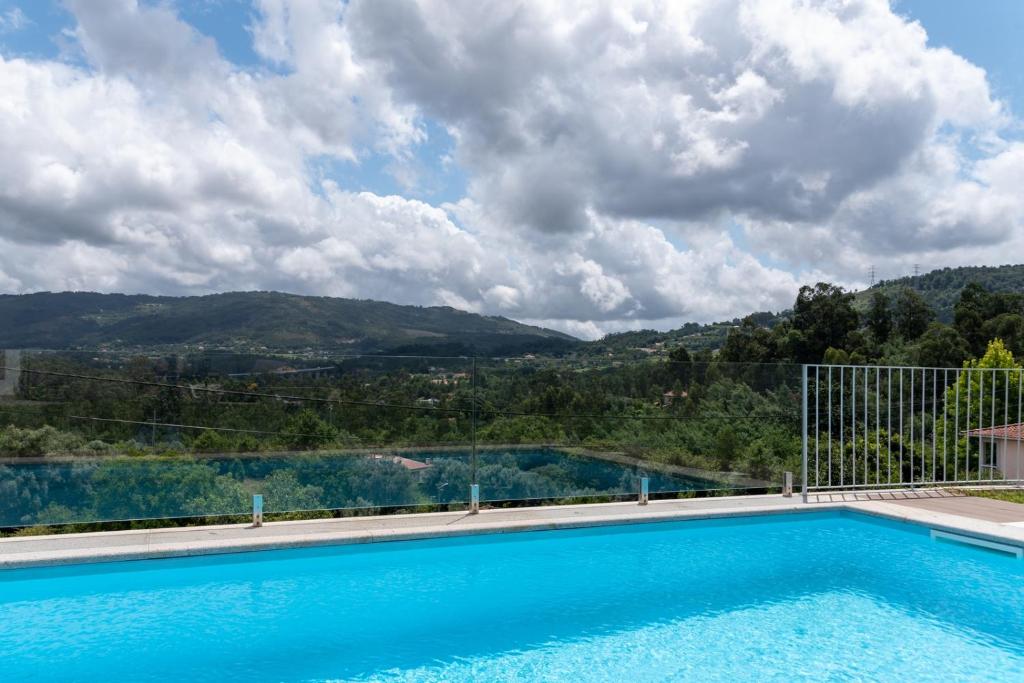 a swimming pool with a view of a mountain at Casa da Gândara 