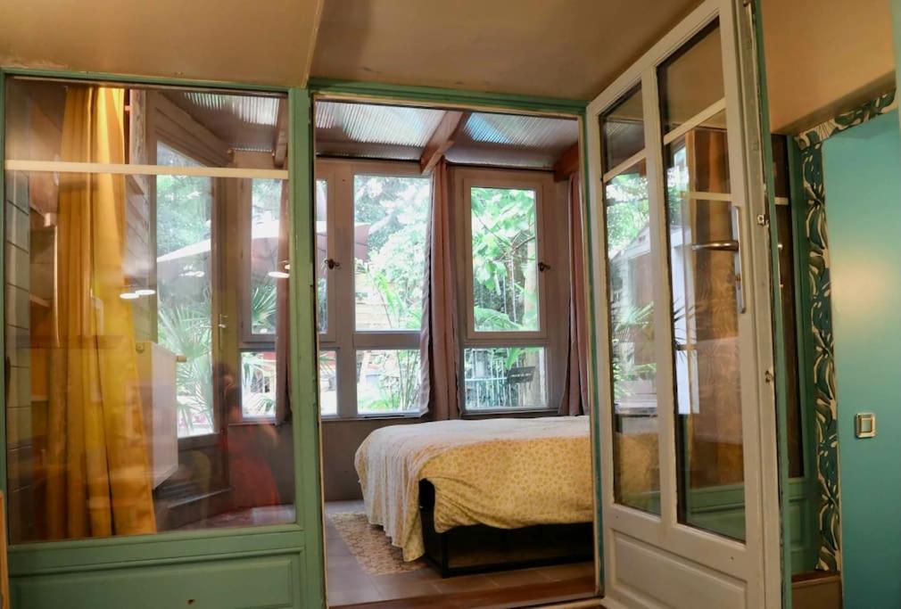 波爾多的住宿－Appartement 1 chambre sur jardin，一间卧室设有一张床和一些窗户。