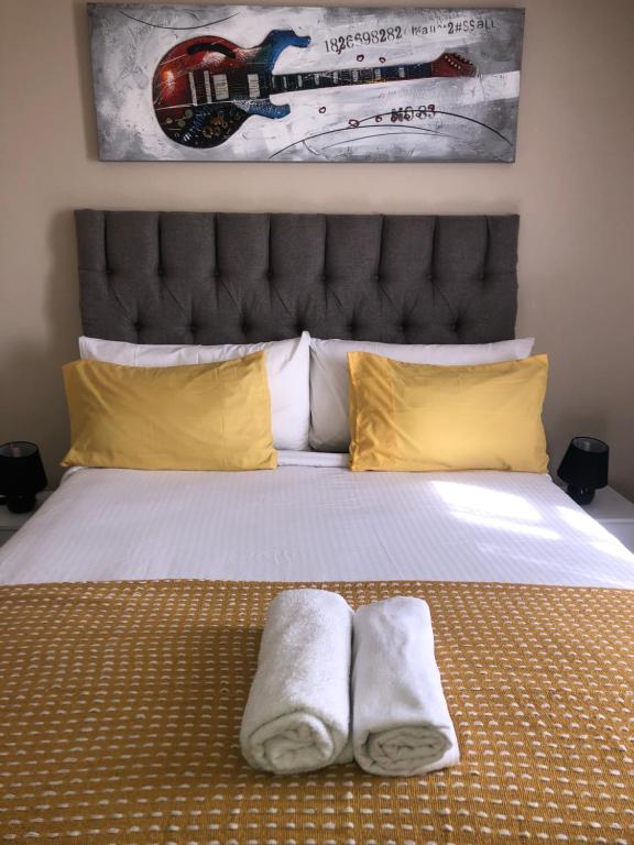 a bedroom with a bed with two towels on it at @Menlyn Place, Menlyn Maine, Pretoria - Accommodation in Pretoria