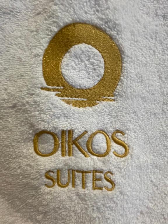 a teddy bear with the word oucos studies on it at Oikos Sani Suites in Sani Beach
