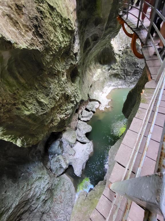 a view of a river from the top of a cliff at La petite Anfiane in Le Grand-Bornand