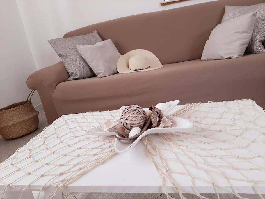 a stuffed animal sitting on a bed next to a couch at Riccione la casetta del paese in Riccione