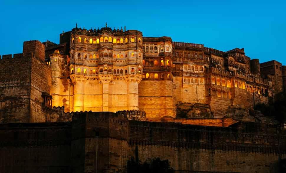a large castle is lit up at night at Inda Heritage Guest House in Jodhpur