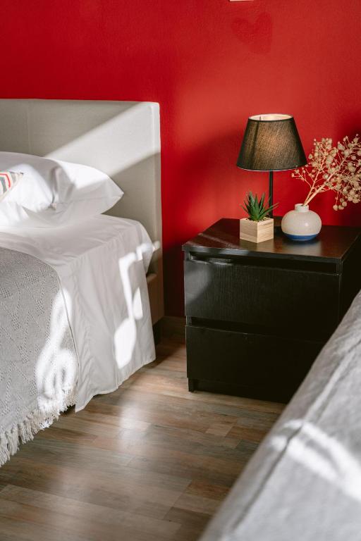a bedroom with a bed and a nightstand with a lamp at Armonia-Art House in Kos