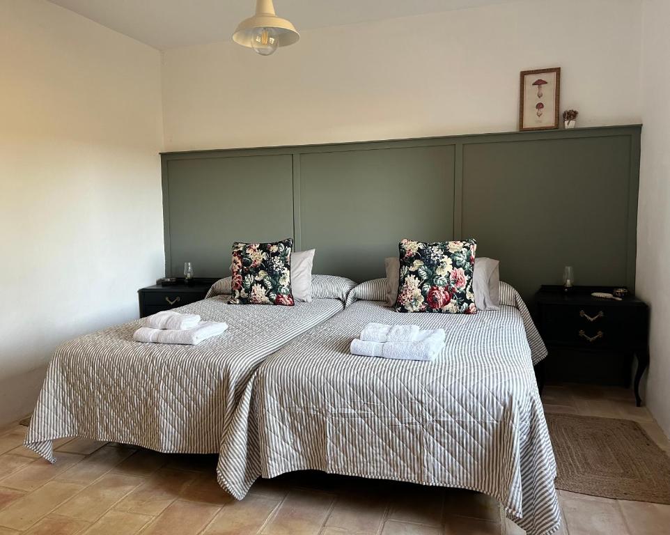 a bedroom with two beds with towels on them at La Morera in Alcaraz