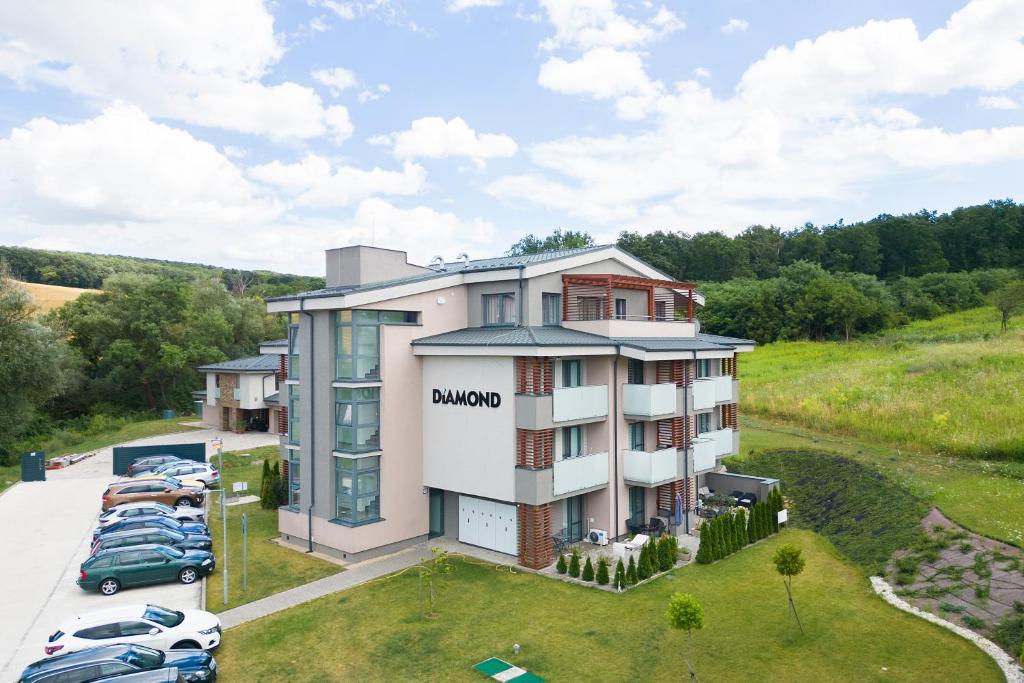 an aerial view of a building with cars parked in a parking lot at Apartmány Meghan in Podhájska